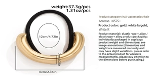 Detail view of 6x2cm golden curved alloy accent on high-elasticity black hair tie band