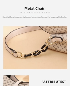 Detail of vintage patterned bucket bag with gold chain strap and fine stitching