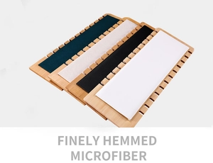 Detail of finely hemmed microfiber and wood display stands for necklaces in multiple colors