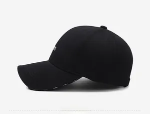 Detailed side view of black cotton baseball cap showing RD embroidery and textured fabric