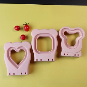 Pink bear shaped sandwich cutter set for DIY bread baking with heart and round patterns
