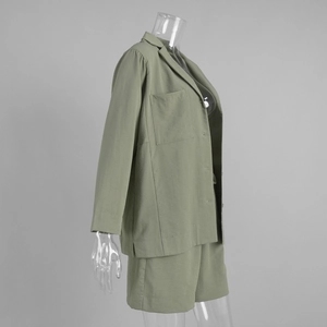 Detail view of sage green notched lapel shirt and shorts set on transparent mannequin