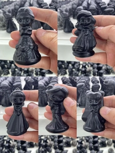 Detailed view of matte black obsidian puppy figurines in various cute princess styles