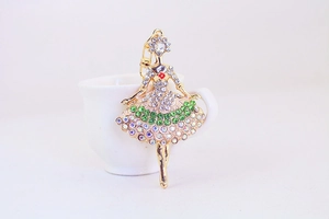 Detail of ballerina keychain with sparkling colorful rhinestones on a white cup