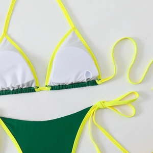 Detail of multi-color bikini showing inner removable pads and neon strappy design