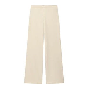 Detail of high-waist cream wide-leg trousers with elegant drape and clean invisible closure