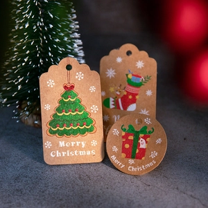 Close-up of Merry Christmas kraft paper gift tags featuring tree and stocking patterns
