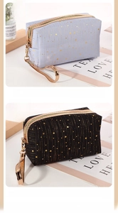 Detail of star-patterned cosmetic bags with sturdy handles and gold star foil prints