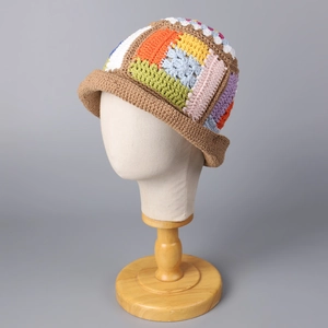 Close-up of handmade colorful crochet granny square bucket hat with floral knit patterns