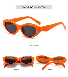 Detail view of oval orange sunglasses with black lenses and geometric cut temples
