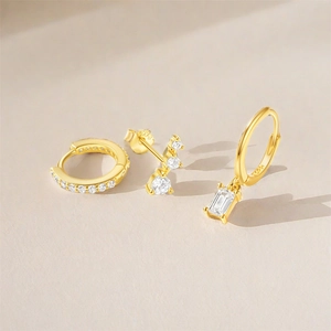 Close-up of S925 sterling silver stamp on gold-plated earrings set with zircon stones