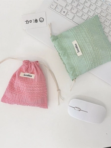 Pastel pink and green drawstring pouches for organizing small digital accessories