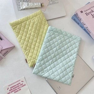 Detail view of quilted diamond pattern padding on soft laptop and tablet sleeve bags
