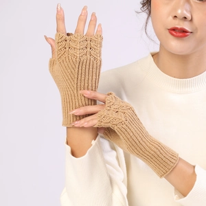 Detail of camel knit fingerless gloves showing intricate fish scale pattern and ribbed cuffs