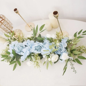 Detail of blue roses and white flowers in a long artificial floral arrangement