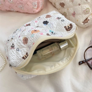 Internal view of a quilted white makeup bag with cute bear patterns and large capacity
