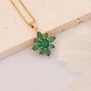 Exquisite gold necklace featuring emerald green zircon flower pendant on stone base