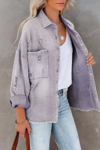 Detail shot of purple distressed denim jacket featuring frayed edges and vintage holes