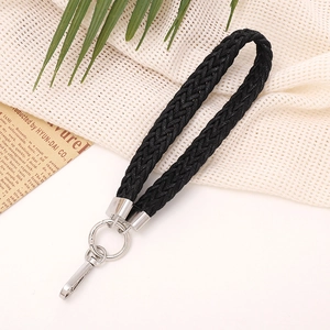 Detail of black herringbone braided wrist strap with polished silver metal ring and clasp