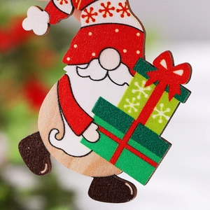 Close-up of painted wooden gnome ornament with red striped hat and beard for Christmas tree