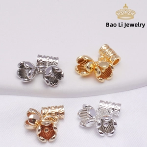 Detailed view of lily of the valley jewelry charms in 14K gold and silver plated metal