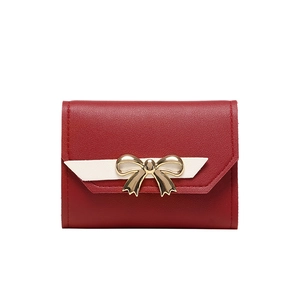 Short red tri-fold leather wallet for women with golden bow and white ribbon accent