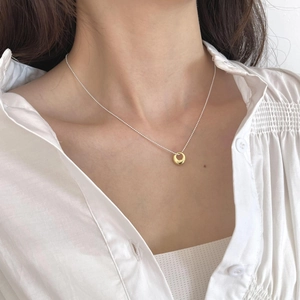 Close-up of S925 sterling silver stamp on minimalist gold ring pendant necklace