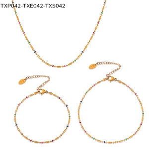 Detail of titanium steel jewelry set featuring gold beads and colorful oil-drip accents