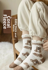 Close-up of thick coral fleece winter socks featuring a cute brown bear pattern design