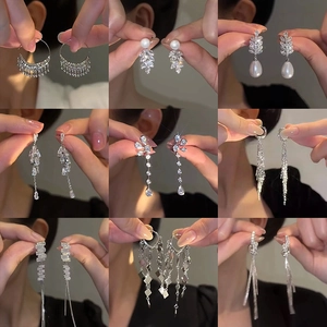 Collection of nine luxury silver tassel earrings with zircon and pearl accents