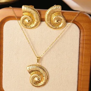 Detailed view of gold starfish and seashell necklace with matching earrings on a board
