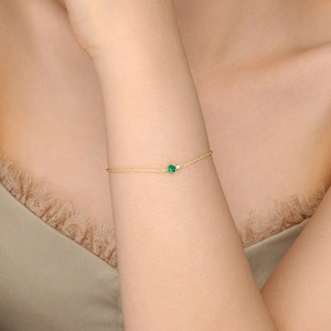 Elegant gold S925 sterling silver bracelet with green zircon worn on woman wrist