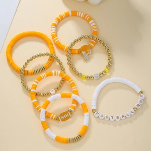 Detailed view of 7pcs yellow and white football mom clay bead bracelets with helmet charms