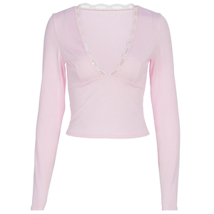 Detail of pink V-neck top showing delicate white lace trim and ribbed knit texture