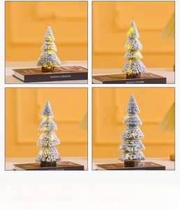 Detailed view of mini snow-flocked Christmas tree with warm LED lights and wooden base