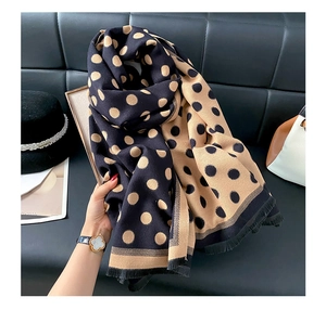 Detail showing soft thick double-sided polka dot scarf with tassel edges and contrast color