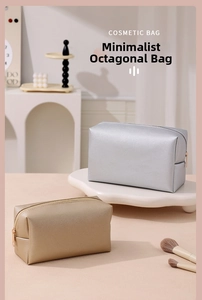 Detailed view of silver and gold octagonal cosmetic bags with cross-grain leather texture