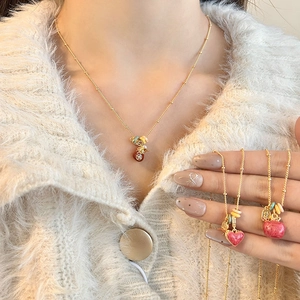 18k gold plated necklace with lucky bag pendant and colorful beads on sweater
