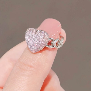 Minimalist silver chain ring with pink heart gemstone on finger in high quality macro view
