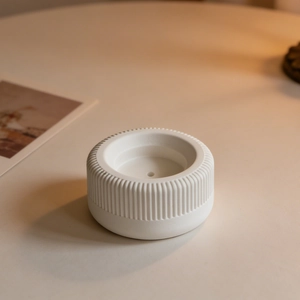 Macro shot of minimalist white ceramic incense holder with vertical striped texture details