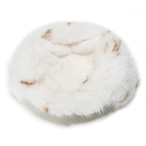 Macro detail of plush faux fox fur texture on the winter earflap hat with brown spots