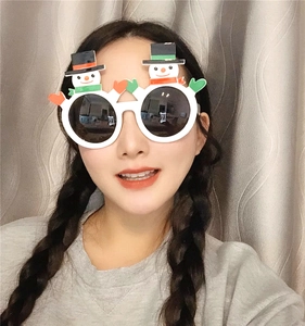 Detail of Christmas party glasses featuring 3D snowman decorations on white frames