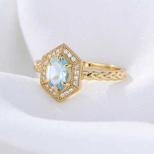 S925 silver gold ring with hexagonal blue topaz and braided band on white silk