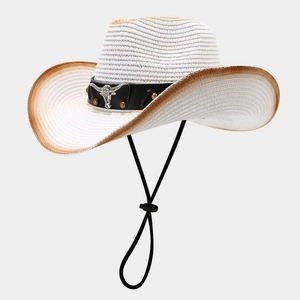 Detail of western straw cowboy hat featuring a black leather belt and silver bull head icon