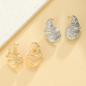 Macro detail of starfish earrings showing brushed metal texture in gold and silver finish