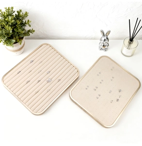 Modern beige velvet jewelry display trays with gold frames for rings and earrings