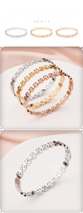 Close-up of three-tone stainless steel bangles with hollow coins and zircon stones
