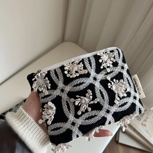 Mini canvas coin purse with white floral embroidery and zipper closure for storage