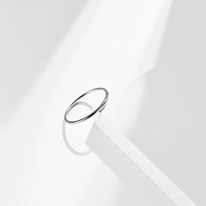 Minimalist stackable 1mm stainless steel ring with a polished silver mirror finish