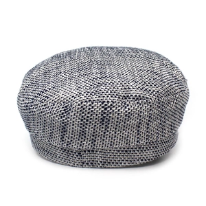 Detailed close-up showing the mixed grey tweed fabric and woven texture of the flat-top military cap
